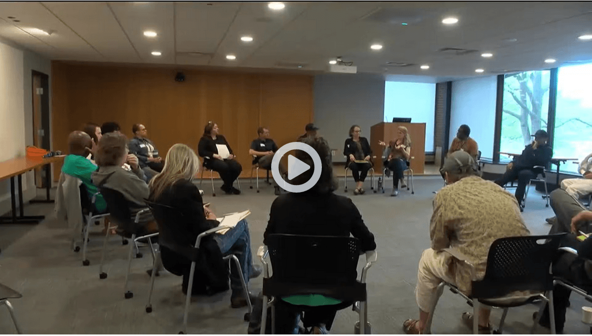 People sitting in a circle in chairs